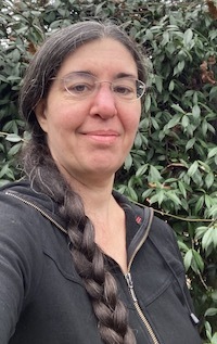 Woman with glasses and long braid over one shoulder